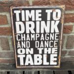Tekstbord: Time to drink champagne and dance on the table